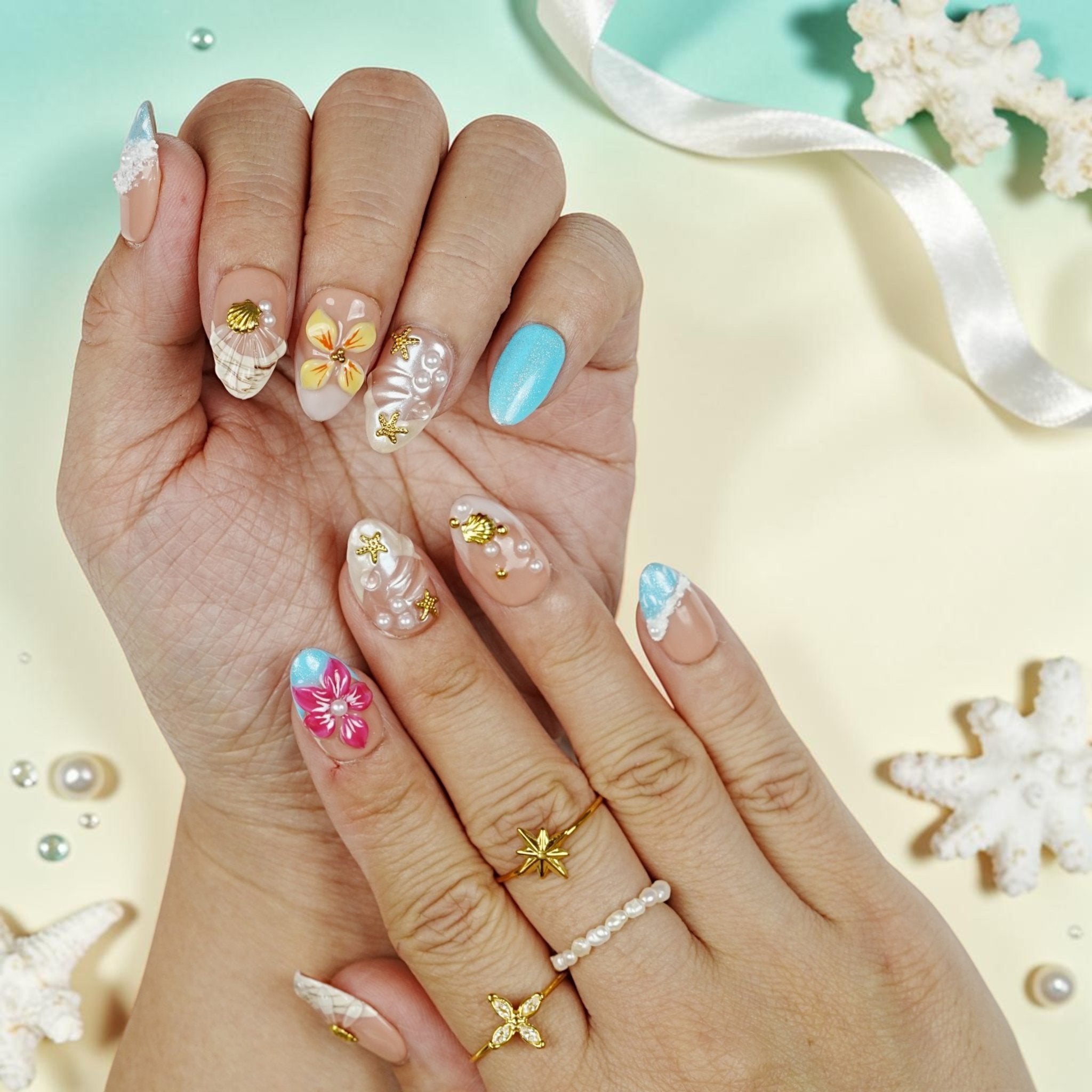 DSC00063 close up of tropical press on nails with 3D shells, pearls and a hot pink hibiscus flower