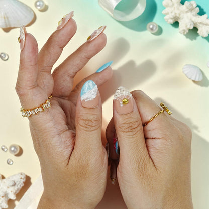 DSC00067 hand wearing tropical press on nails with a 3D scallop shell and gold seashell charm