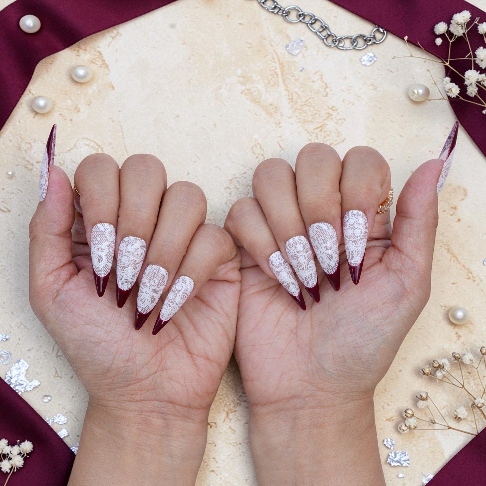 DSC00068 pair of hands showing burgundy lace press on nails from the front