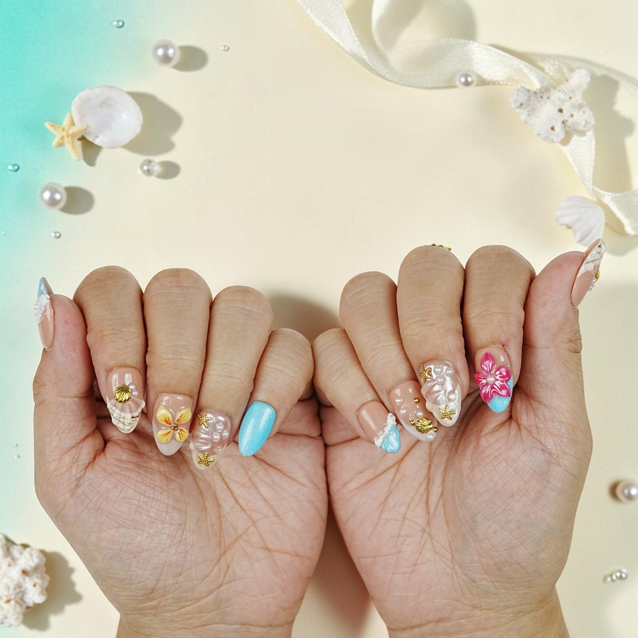 DSC00068 two hands showing tropical press on nails with 3D flowers, shells, pearls and aqua tips