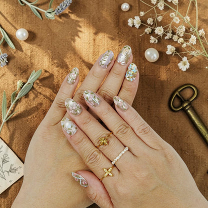 DSC00071 hand wearing wildflower press on nails with pink and blue painted flowers