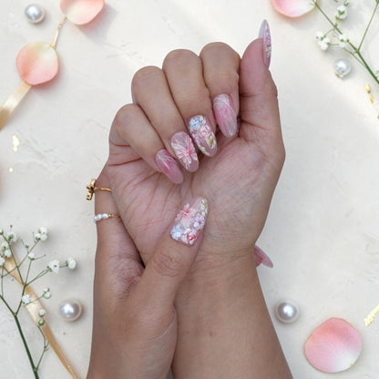 Blushing Bride press on nails styled with pearls and rose petals
