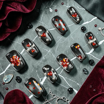 DSC00083 gothic press on nails full set black cat eye with red heart gems silver studs and crystals laid flat