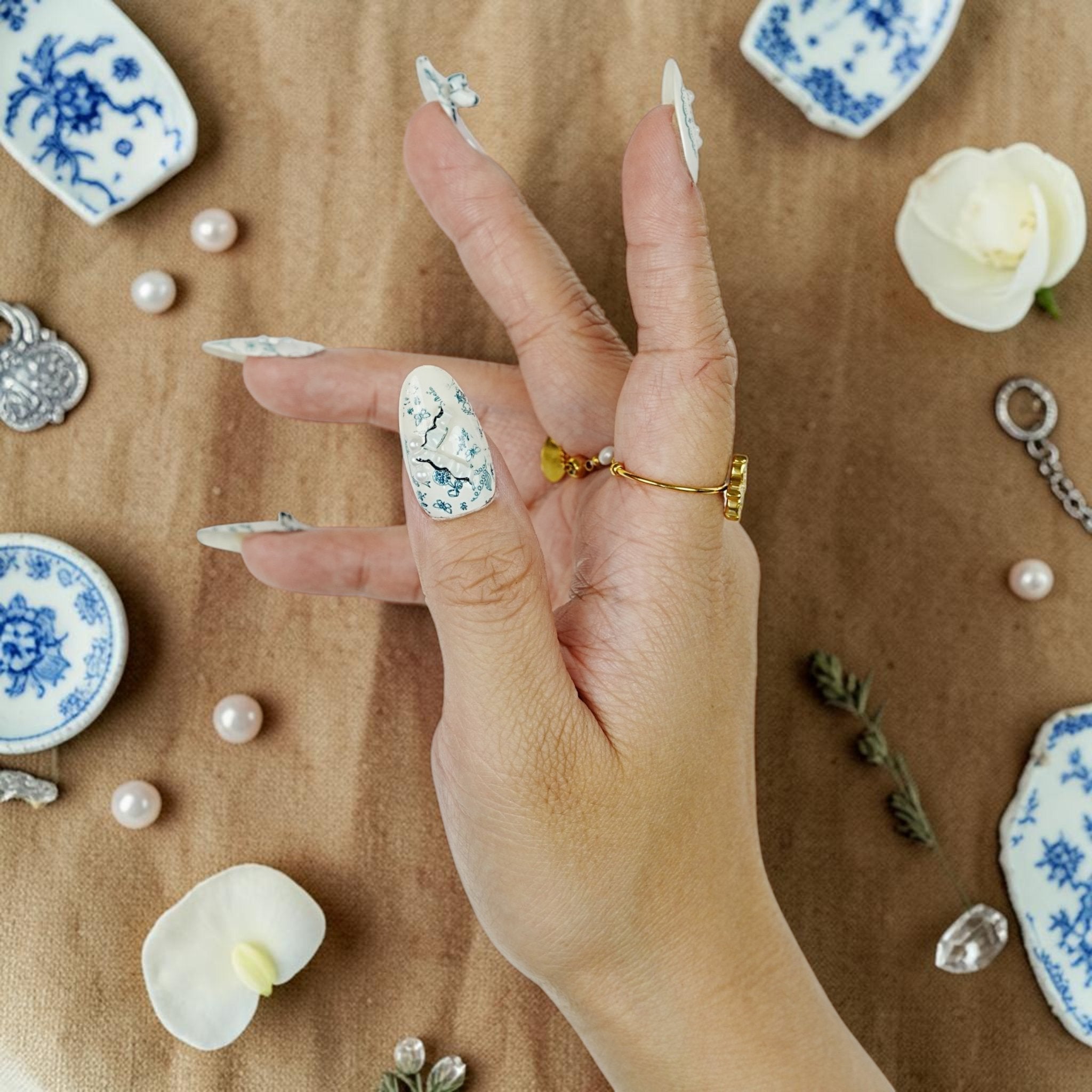 DSC00098 close up of blue toile florals and 3D pearls on porcelain press on nails