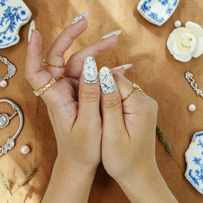 DSC00099 hands wearing blue and white porcelain press on nails with pearls and bows