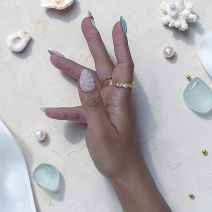 Almond ocean press on nails with sculpted shell, pearls and gold foil detail on hand