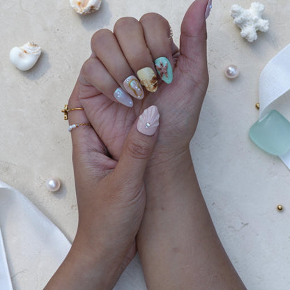 Handmade ocean press on nails with 3D fan shell and pearl on a soft pink base