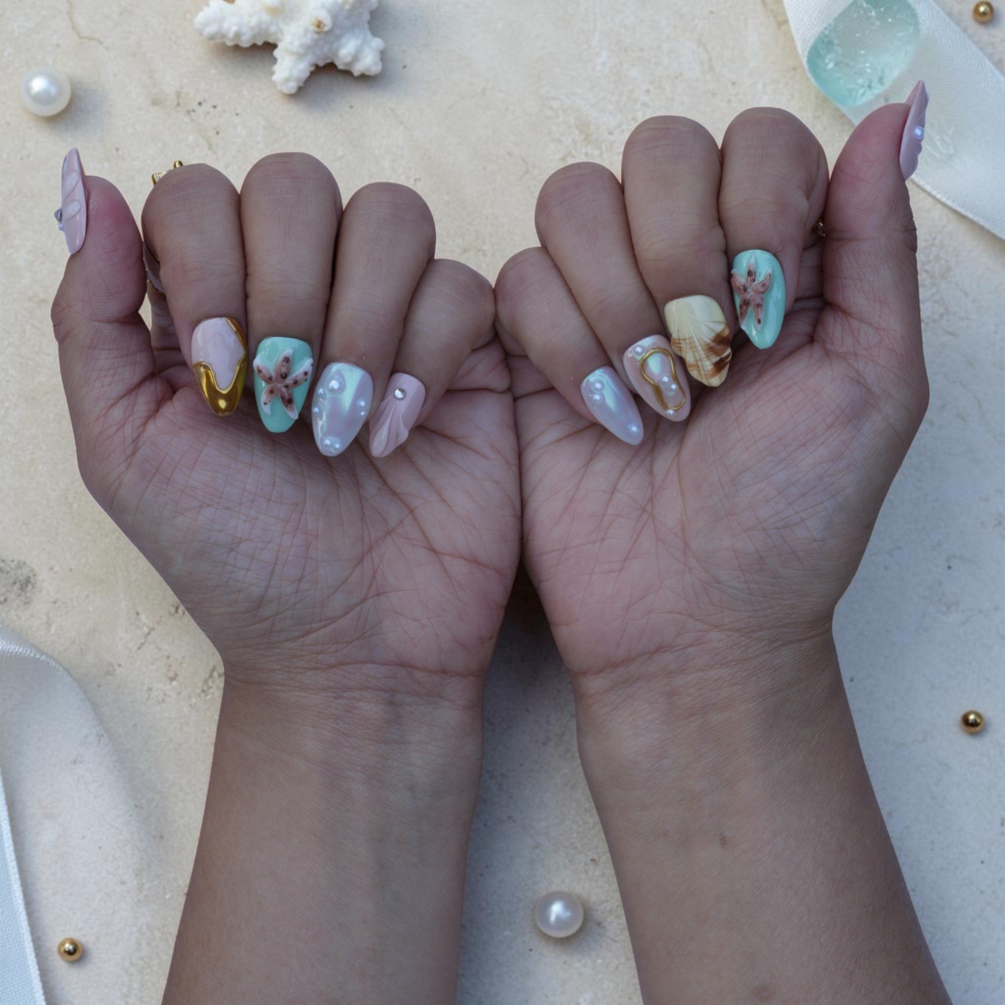 Pastel ocean press on nails set on both hands in mint, pearl, pink and gold