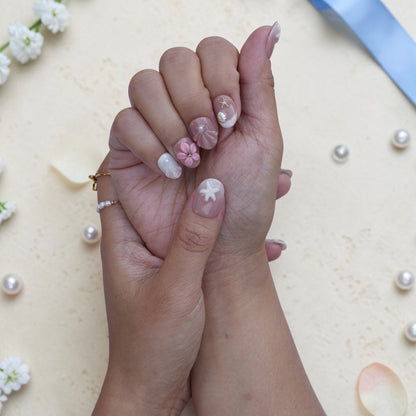 Soft pink press on nails with pearl accents and gentle marble detail