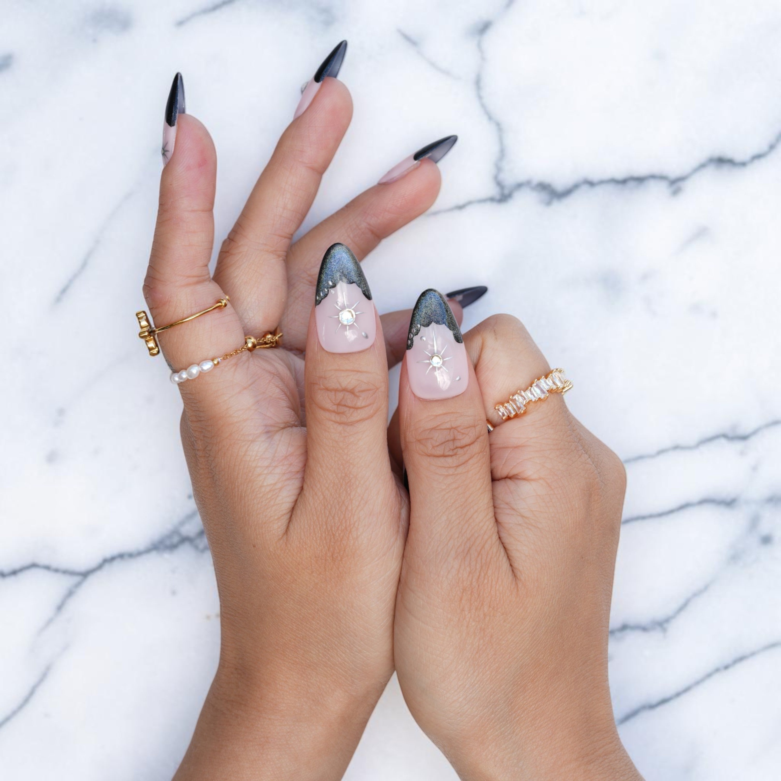 Midnight nude almond nails with dark French tips and celestial stars