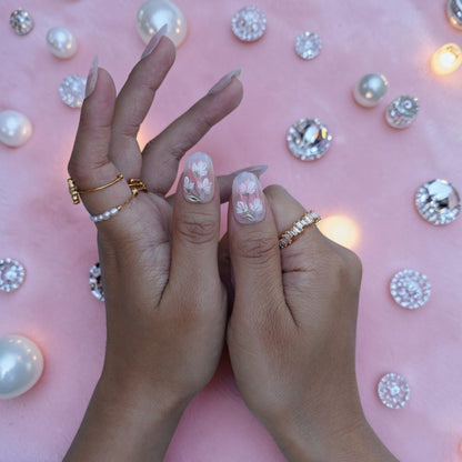Delicate white flower press on nails in a sheer milky nude base