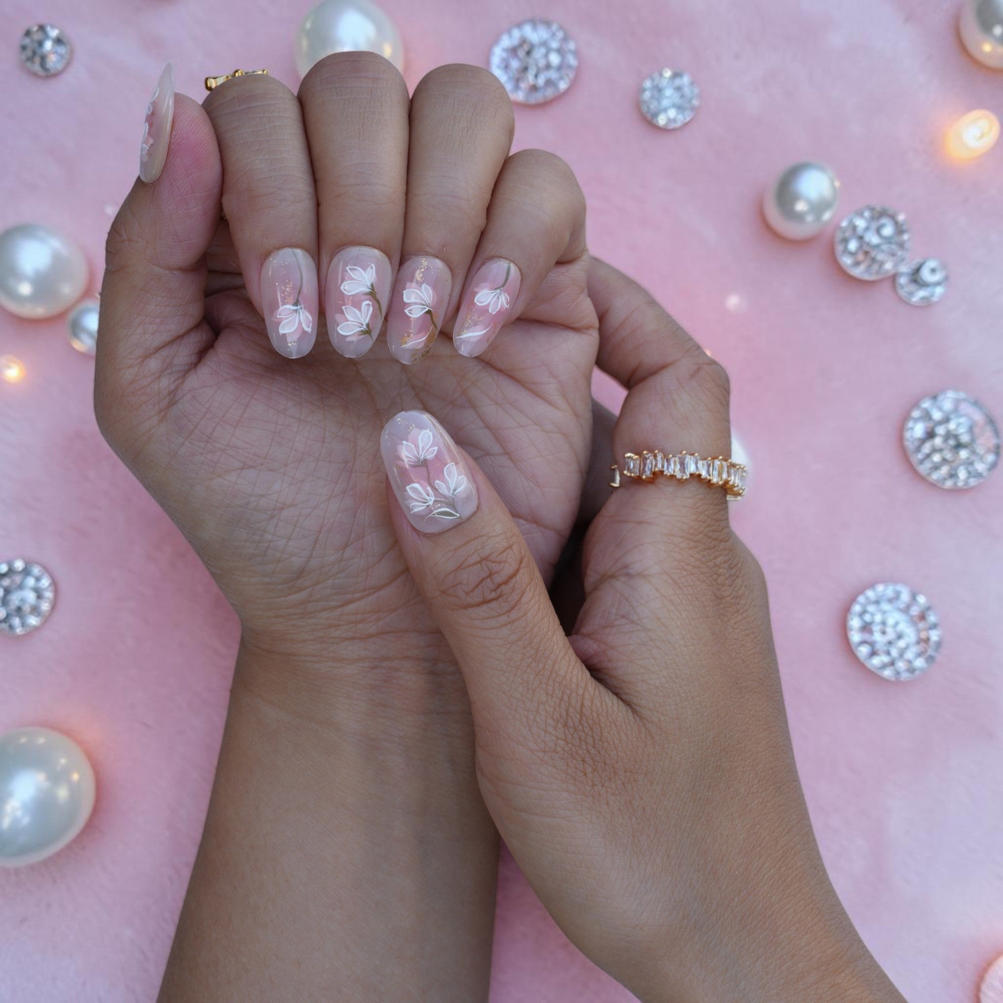 Bridal style nude press on nails with painted magnolias and green stems