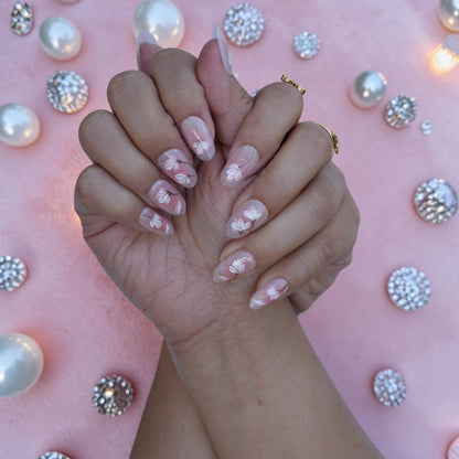 Elegant nude press on nails with white florals and gold flecks