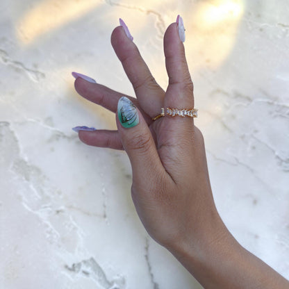 Mint green nail with silver wing art on a pastel press on set