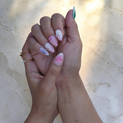 Pastel iridescent press on nails on both hands with dewdrops and silver swirls