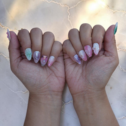 Both hands wearing Opal Dream pastel aura press on nails with 3D flowers and butterfly art