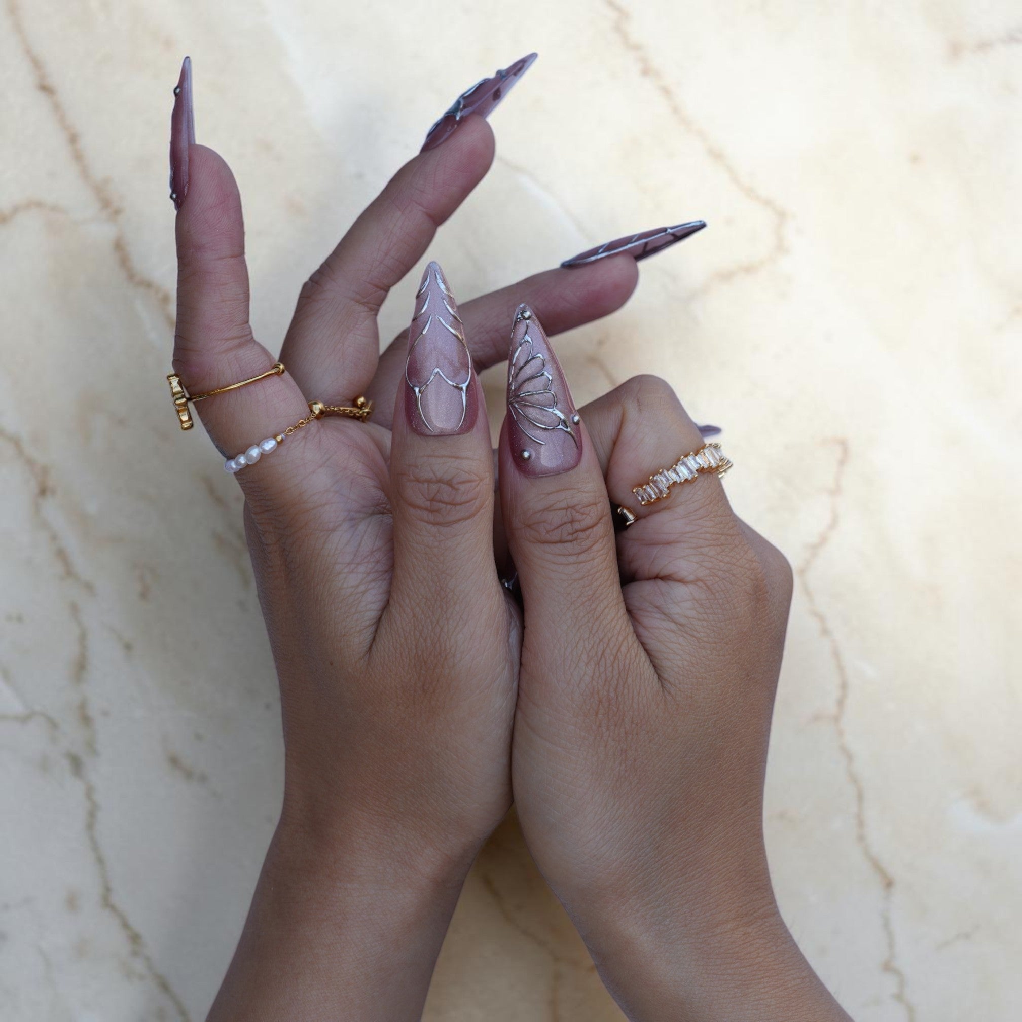 Long mauve stiletto press on nails with silver leaf and butterfly wire work