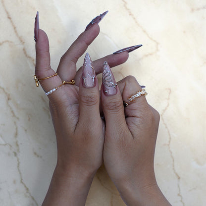 Long mauve stiletto press on nails with silver leaf and butterfly wire work