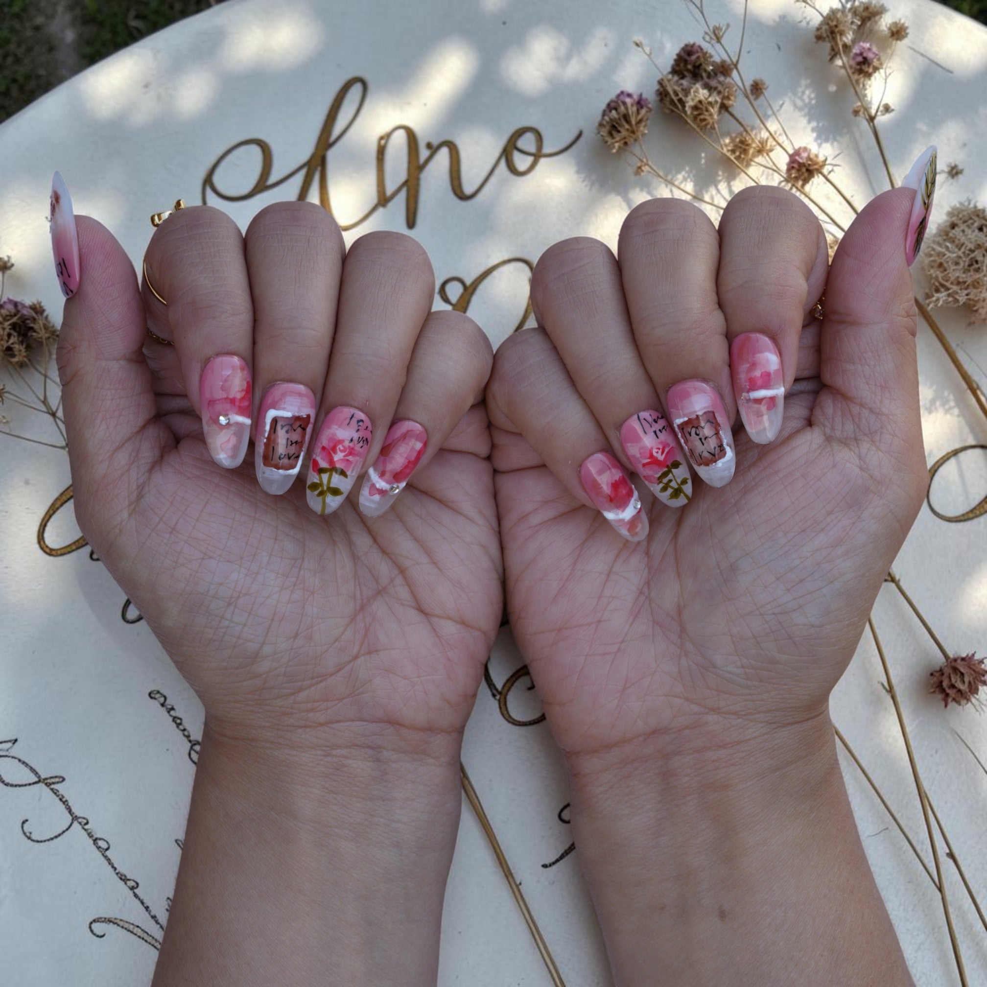 Both hands wearing Love Letter vintage rose press on nails set