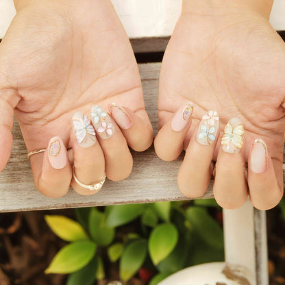 Full hand shot with pastel butterfly press on nails – handmade 3D nail art