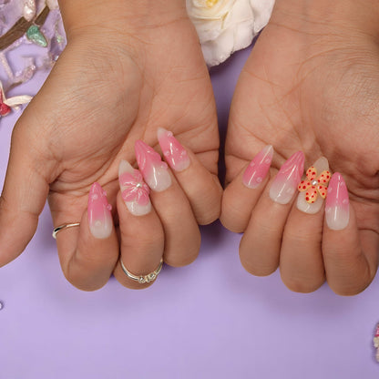 Double-hand pose showing Petal Pop press on nails with alternating flower designs and glossy pink finish
