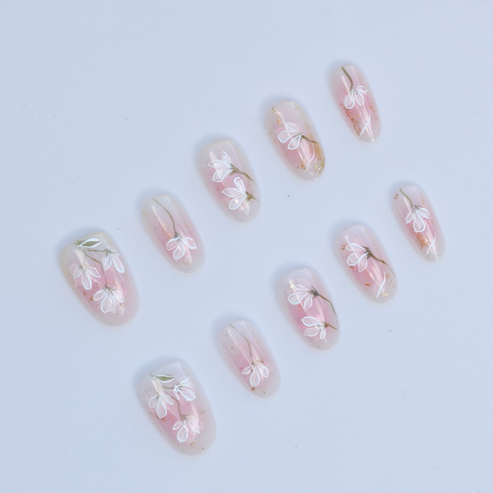 Magnolia Mist bridal press on nails full set in sheer nude with white magnolia flowers and gold flecks
