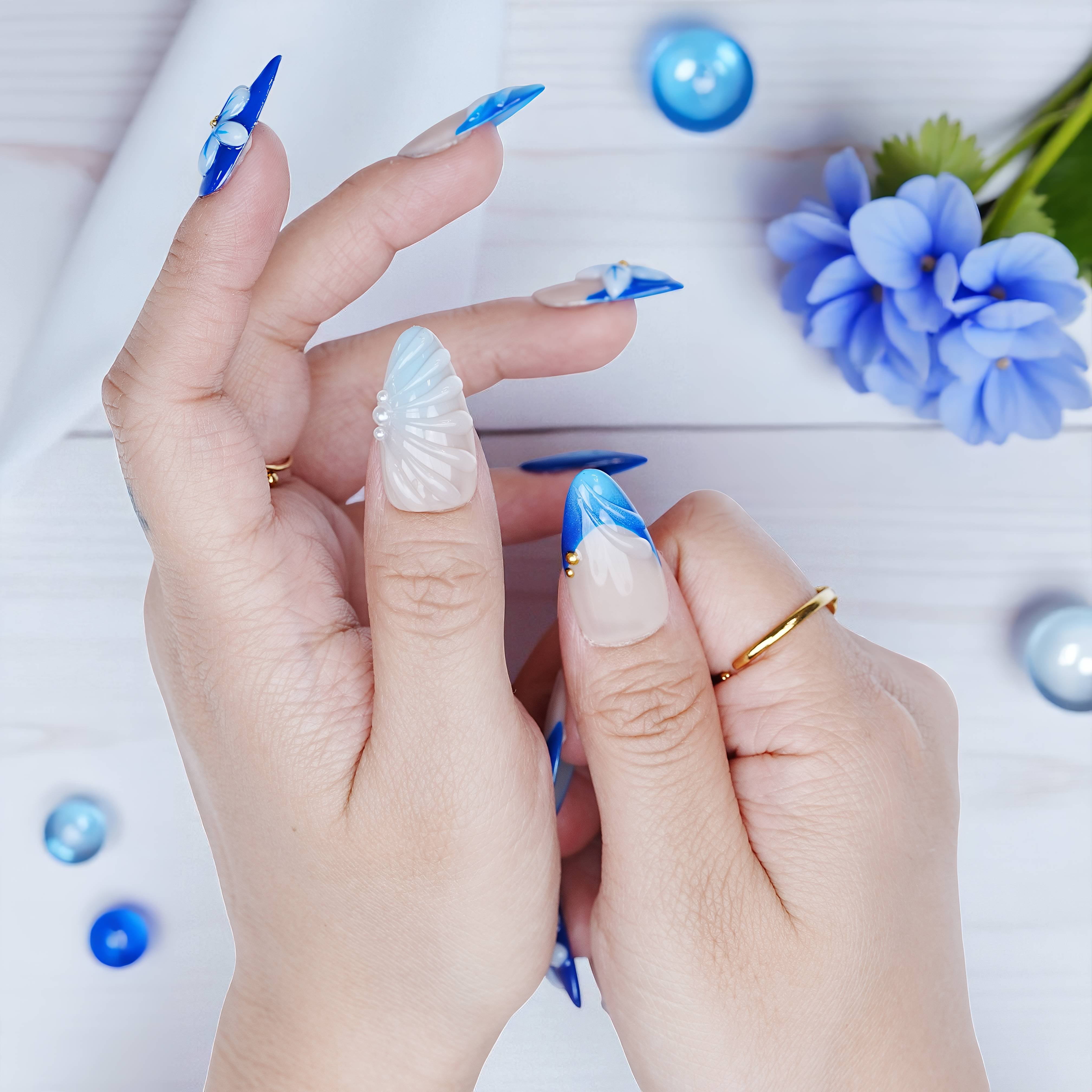 Single-hand pose showing crystal-like texture and floral design with cool tones and soft blue gradients.