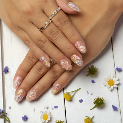 Pastel floral reusable nails with pearl details and butterfly art on neutral base
