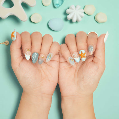 Ocean-inspired press on nails with sculpted orange starfish and sandy blue tones – coastal summer vibes.