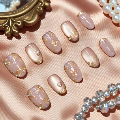 Gold floral cat’s eye nails with shimmer and pearl embellishments