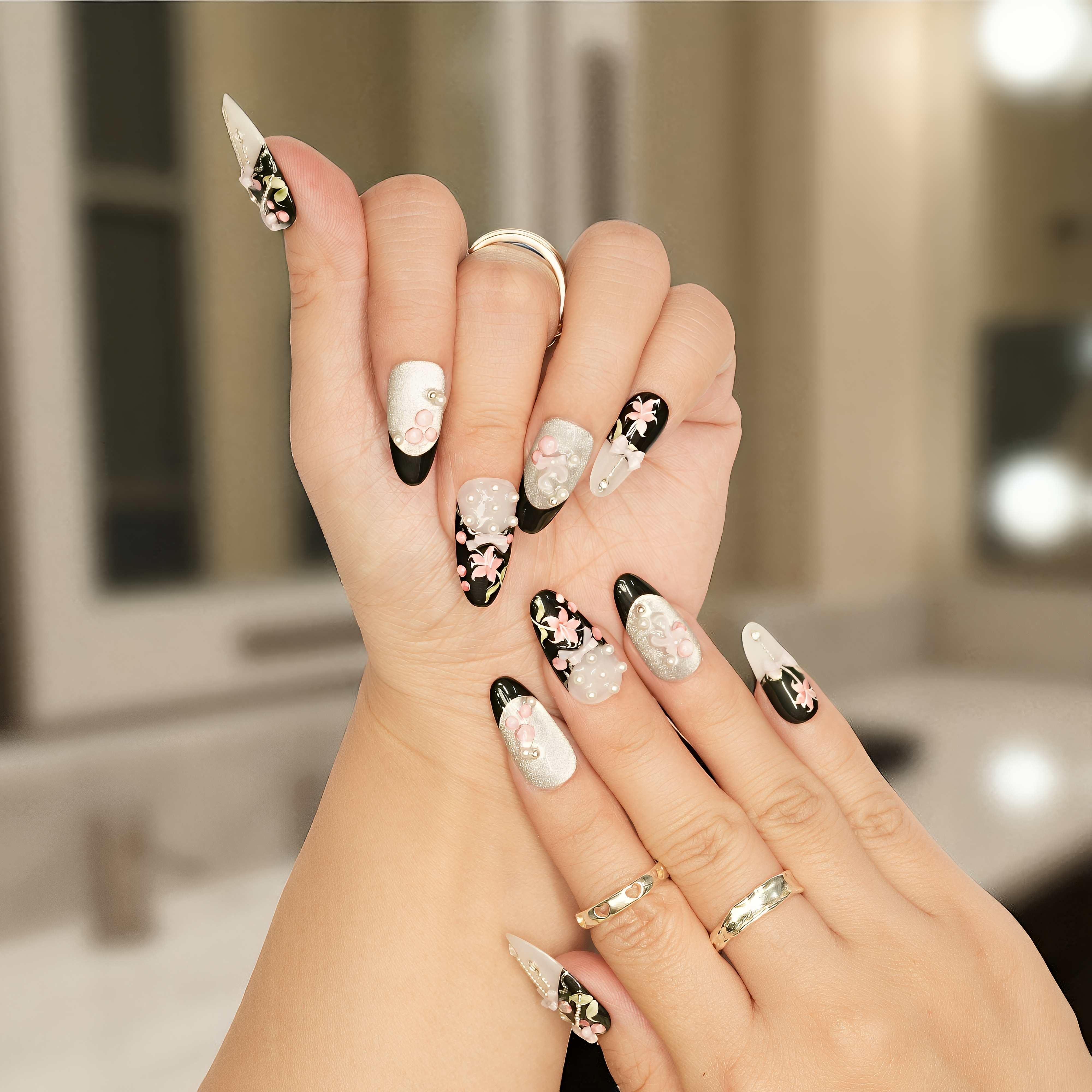 Press on nails in black and pearl with 3D floral and bow details, perfect for romantic styles.