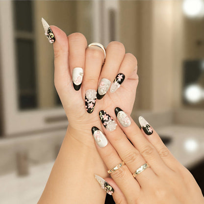 Press on nails in black and pearl with 3D floral and bow details, perfect for romantic styles.