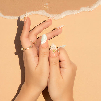 Handcrafted nail press on nails in soft peach and mint green tones