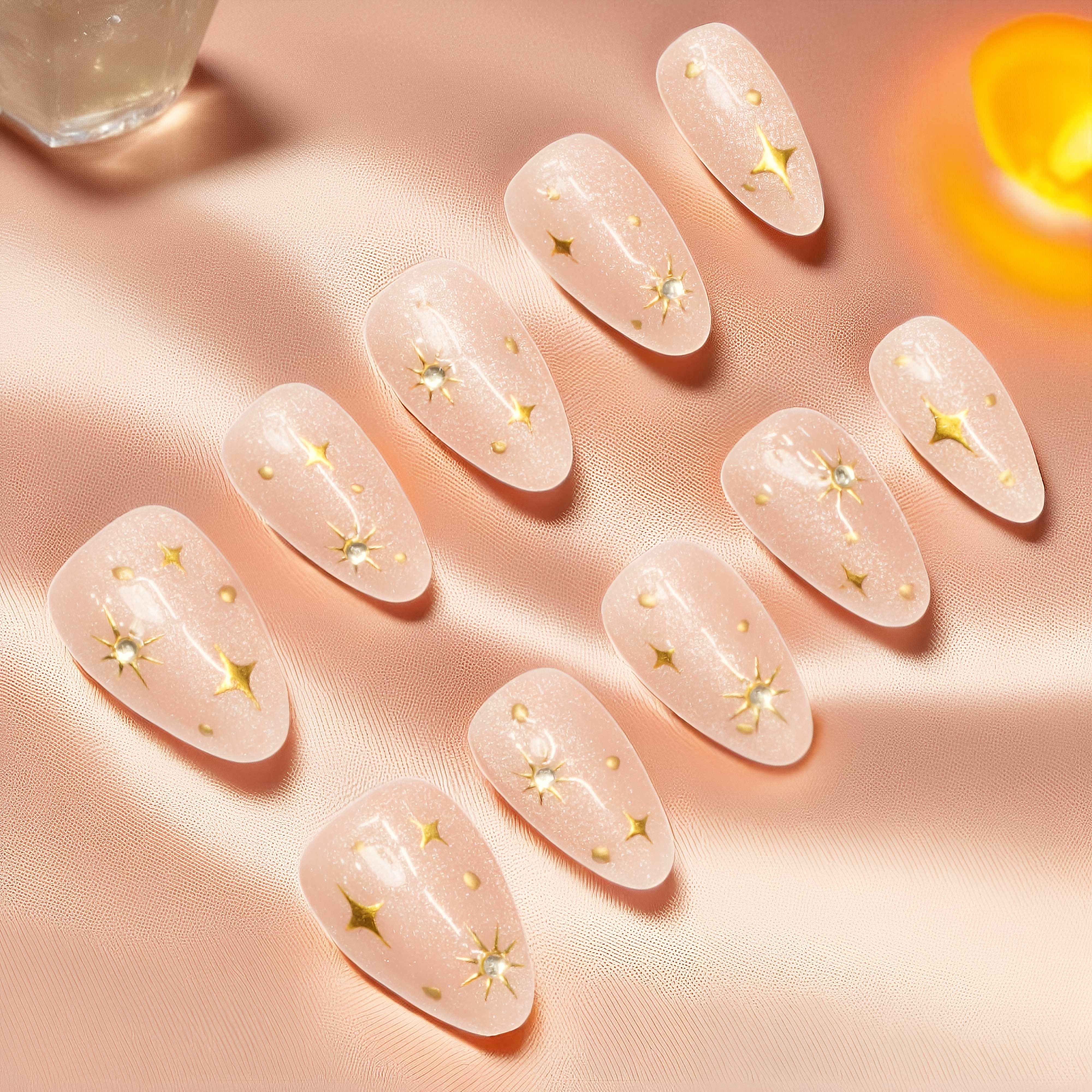 Set of press on nails laid out, nude with crystal and foil details, handmade false nails from Adelaide.