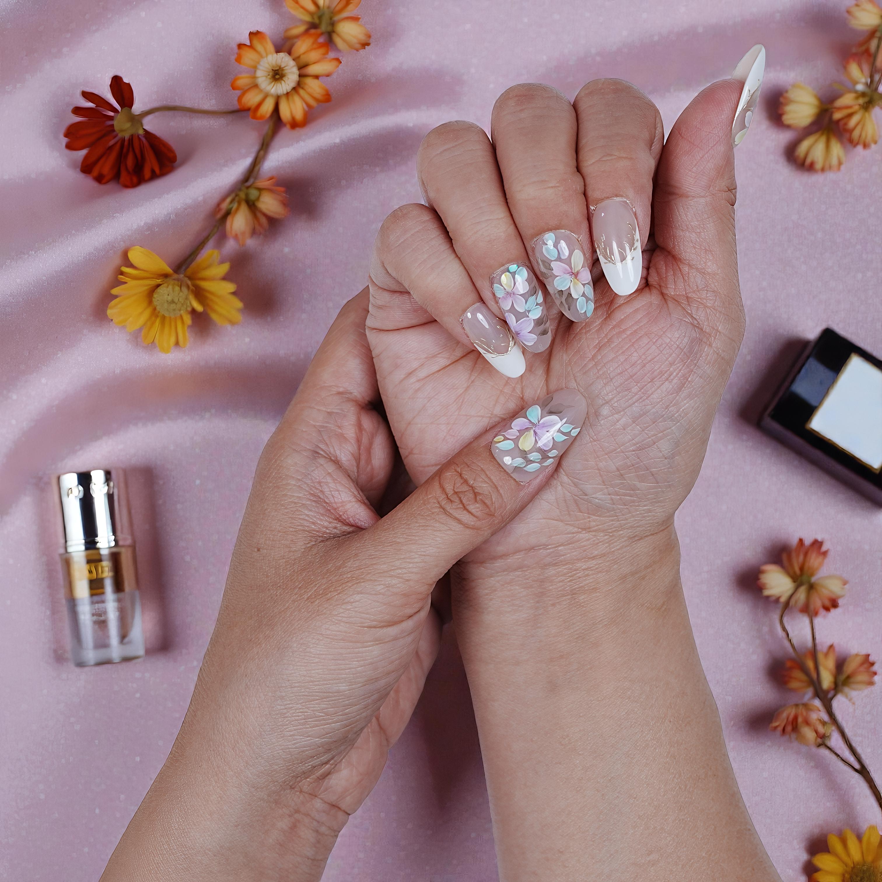 Handmade stick on nails in Blooming Mist palette – baby blue, pink, and lilac tones
