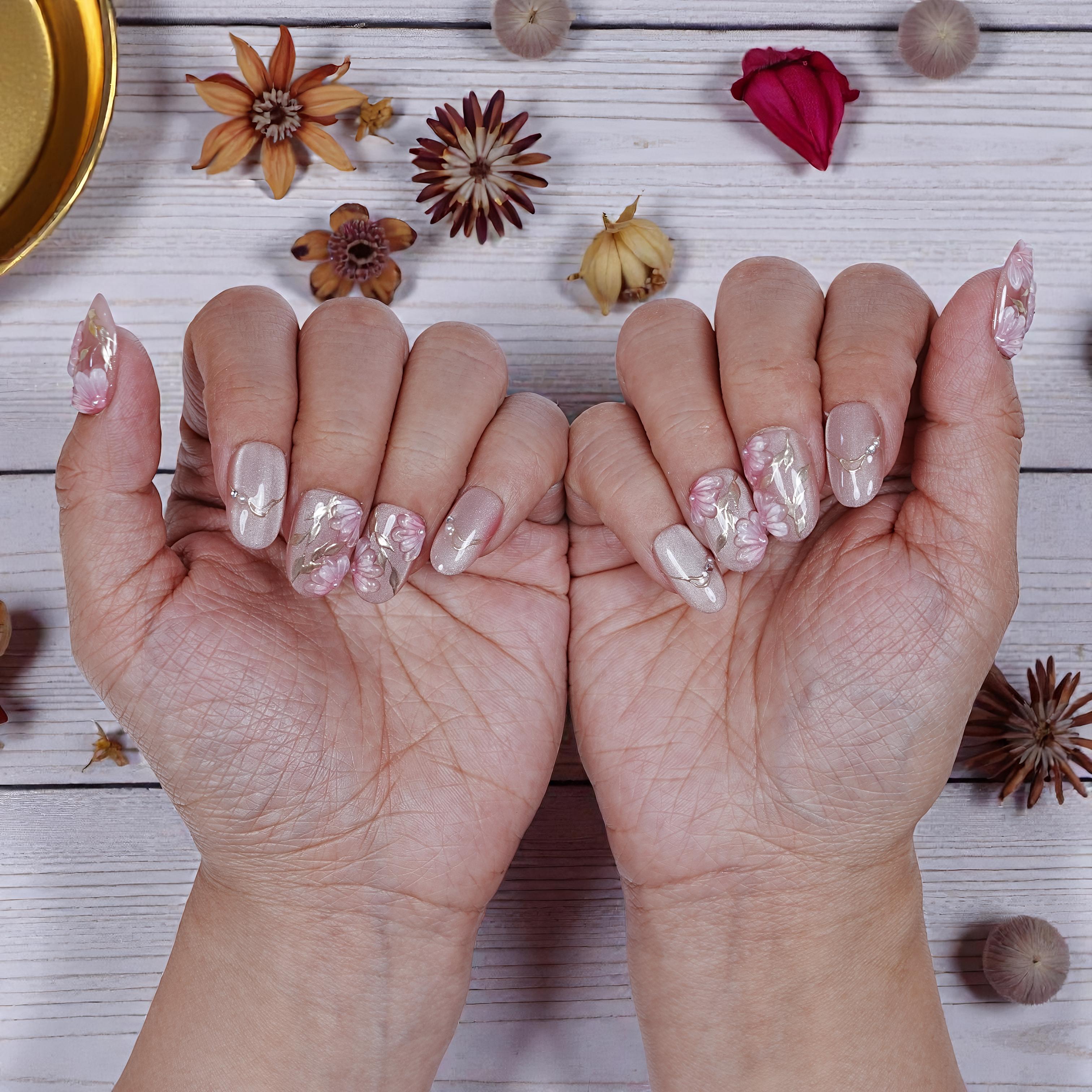 Sakura Glint press on nails featuring soft pink hues and cherry blossom floral details