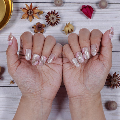 Sakura Glint press on nails featuring soft pink hues and cherry blossom floral details