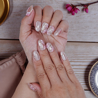 Closeup of Sakura Glint nails showing delicate pink and white accents