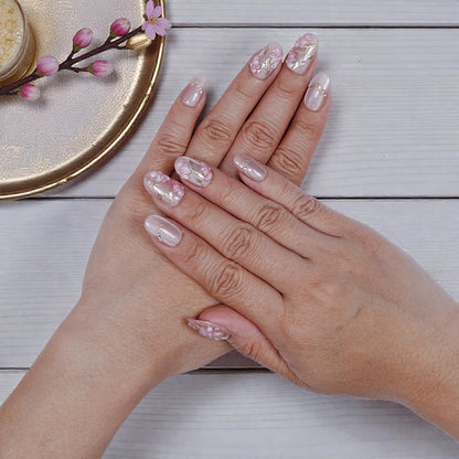 Sakura Glint nails displayed with jewellery for styling inspiration