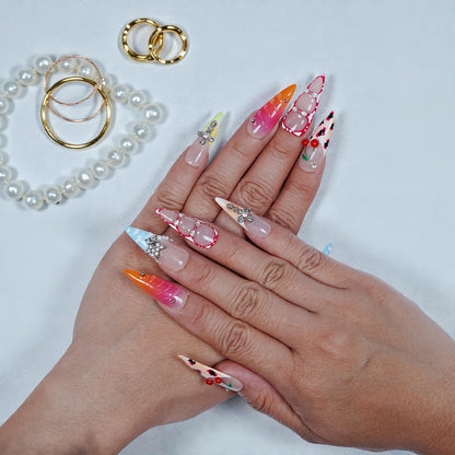 Hand model showing full set of ombre and gem press on nails with glue
