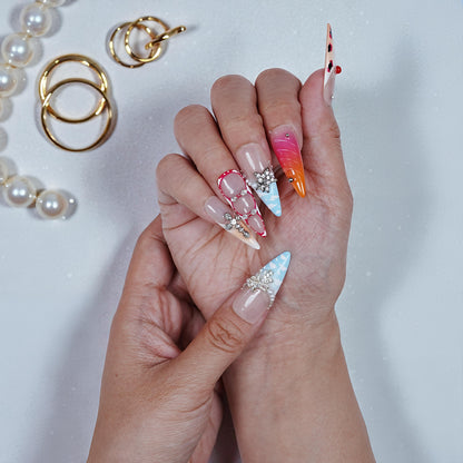 Both hands showing stiletto press on nails with rhinestone