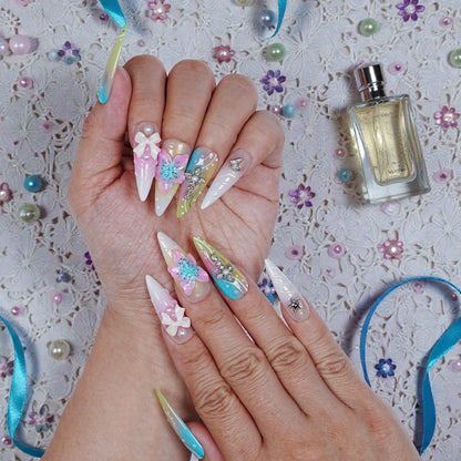 Full view of both hands with Aurora Belle Garden nails in daylight showing shimmer and 3D sculptural design