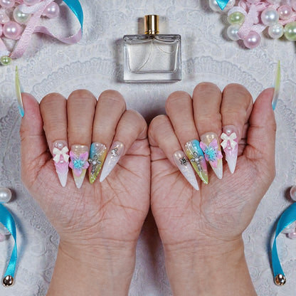 Close-up of middle finger detail showing 3D flower, pearl bead, and gold embellishments in Belle style