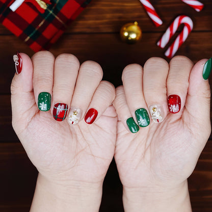 Full hand view of holiday nails in Christmas red and green with sparkle detail