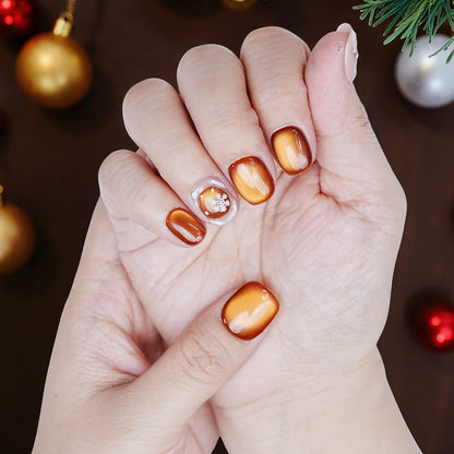 Cozy holiday setting with hand modeling Christmas tree and bronze nails