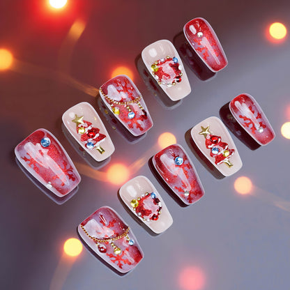Press on nails in scarlet red with 3D Christmas trees, gem wreaths and snowflake accents on a reflective festive background