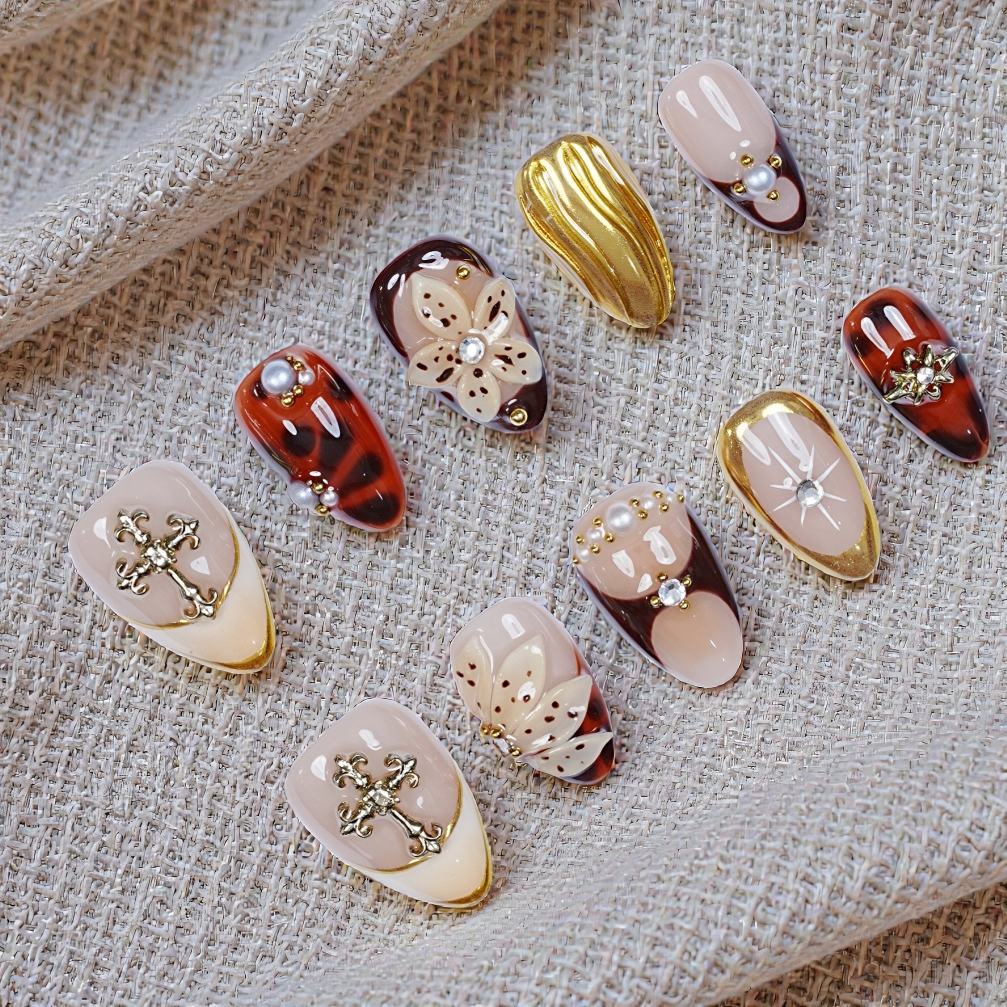 Luxury press on nails with nude base and gold chrome detailing flat lay