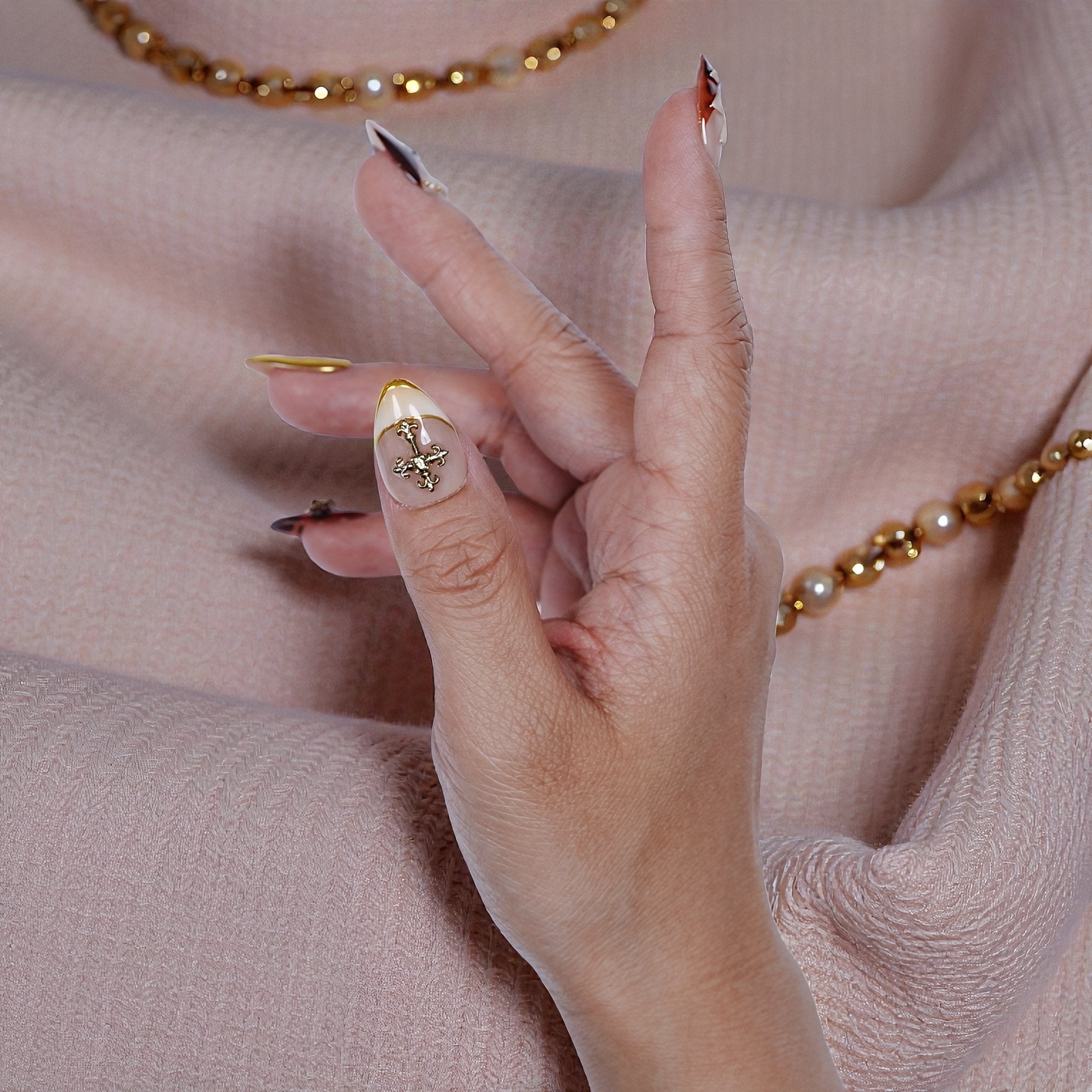 Elegant luxury press on nails with neutral tones and metallic details