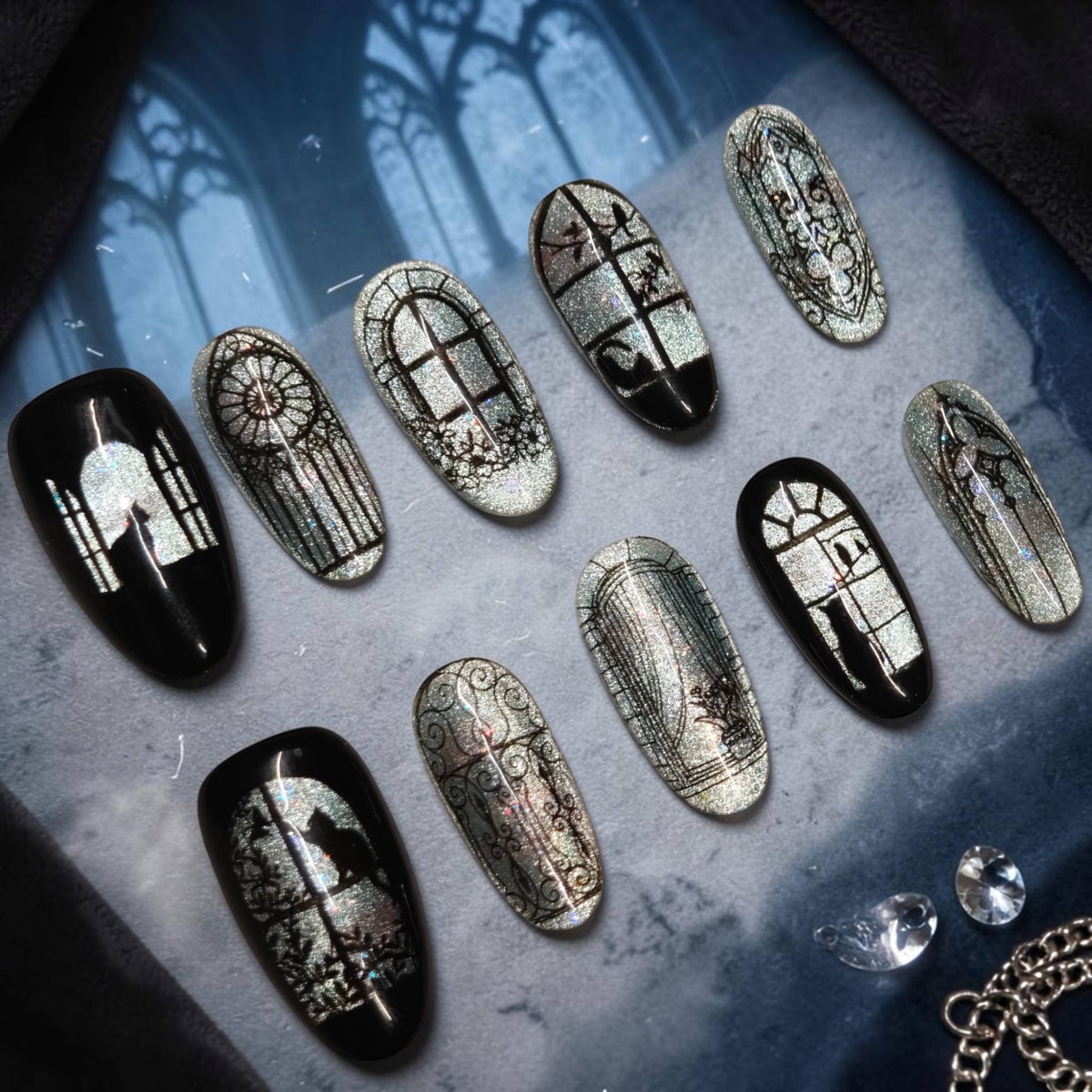 Cathedral Nights silver cat eye press on nails with gothic windows, rose window, black cats and crows on almond nails