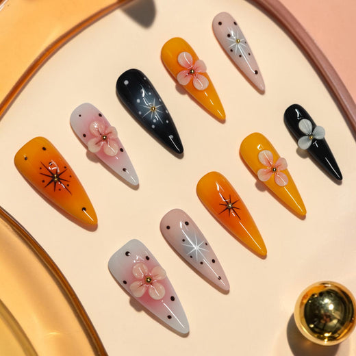 Pumpkin Blossom orange press on nails, long stiletto Halloween set with black starbursts, gold beads and 3D pink flowers